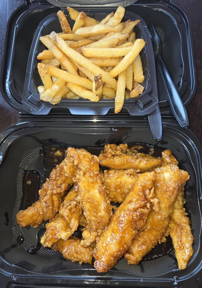 Stinging Honey Garlic chicken strips with fries photographed at the restaurant